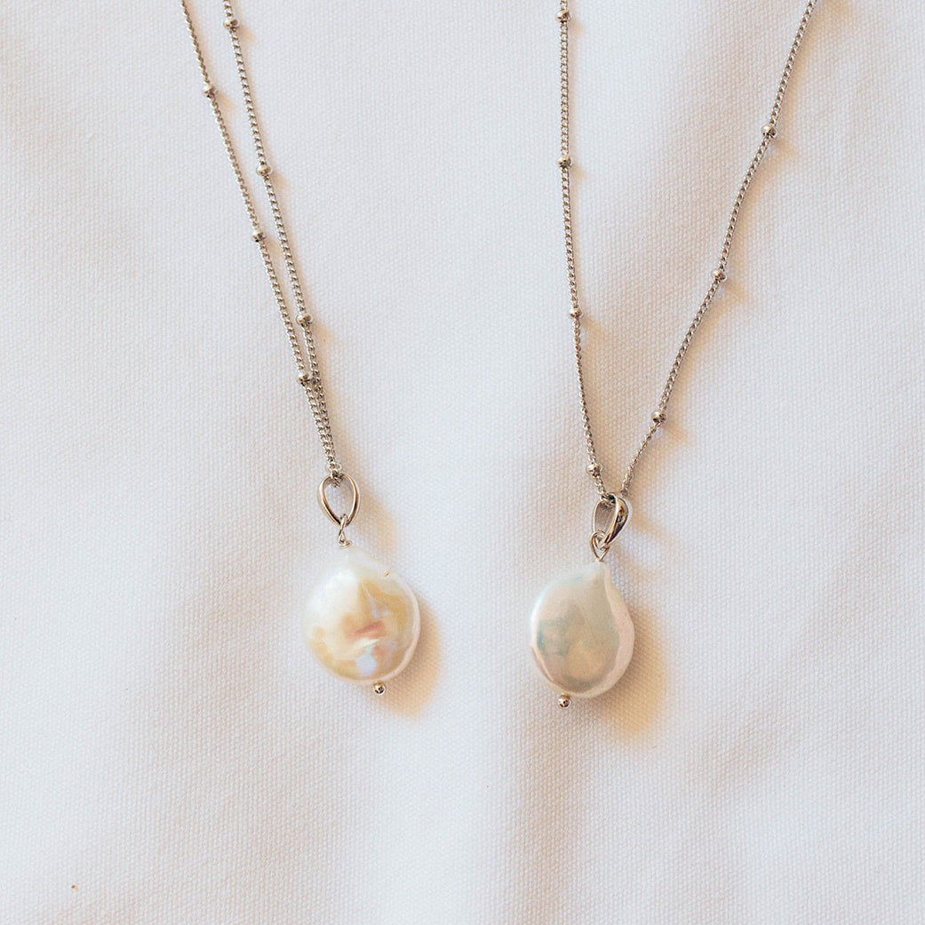 two pearl pendants on satellite chains in silver