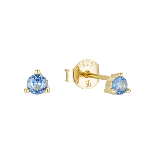 Gold earrings with blue gemstones on a white background