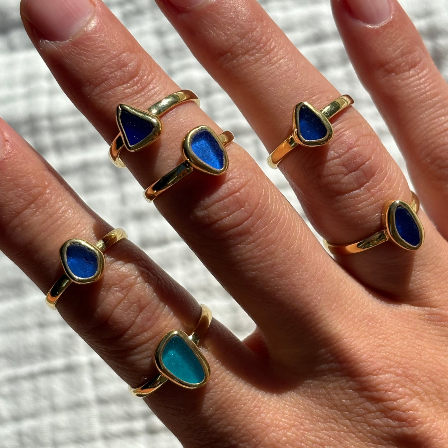 blue sea glass rings stacked in gold vermeil