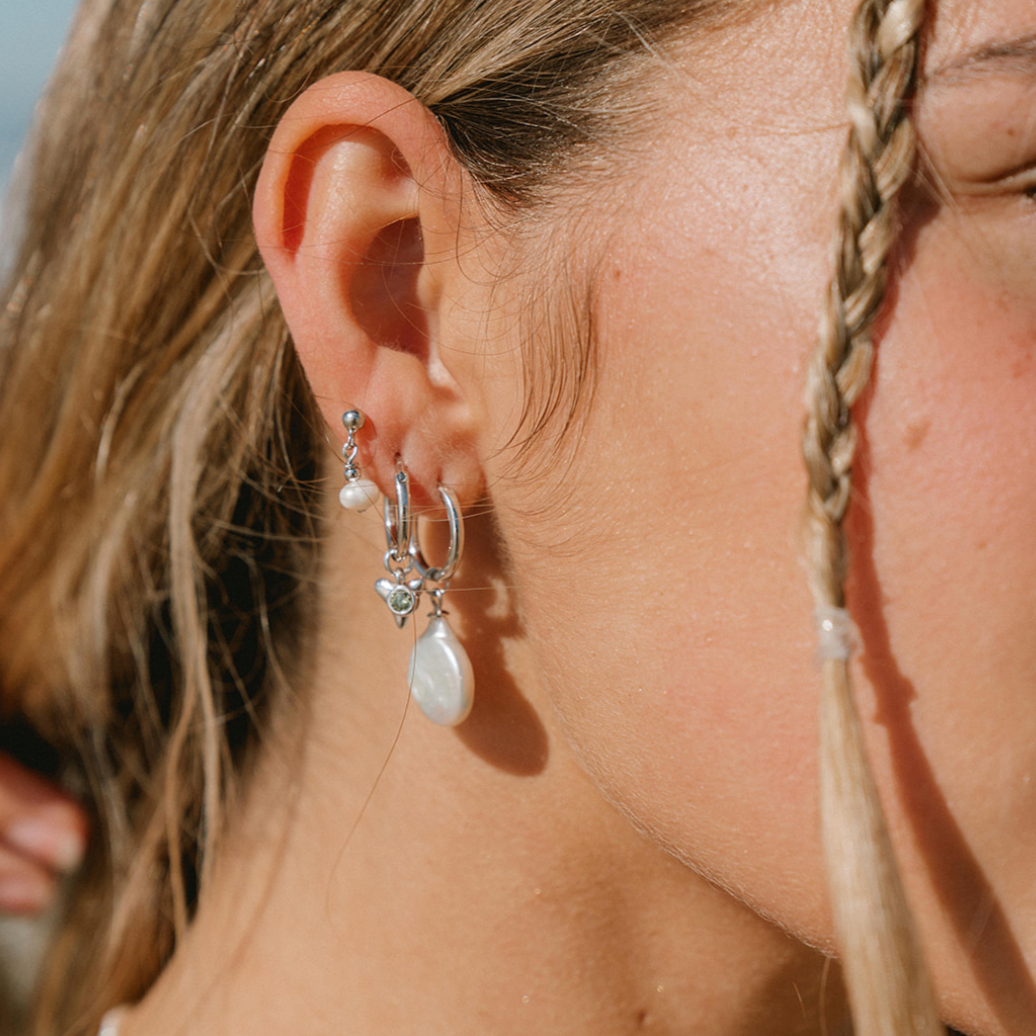 pearl earring charm stacked on an earring model