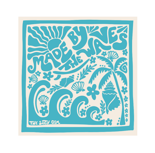 Decorative towel with ocean-themed design and 'Made by the Waves' text on a white background