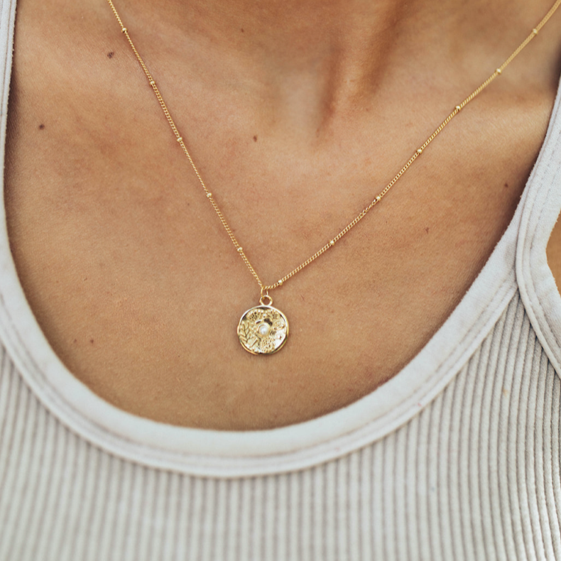 necklace with coral embossing on it